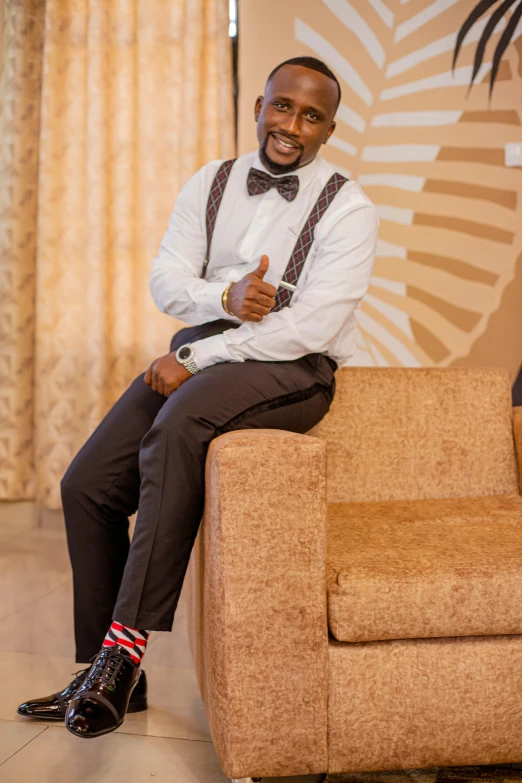 a man is posing for the camera while sitting on a couch