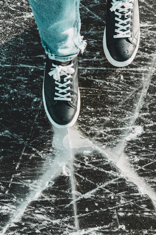 a close up of an person's feet in tennis shoes