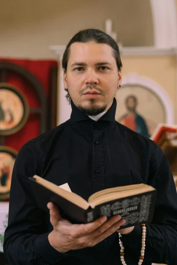 a priest holding the bible in a church