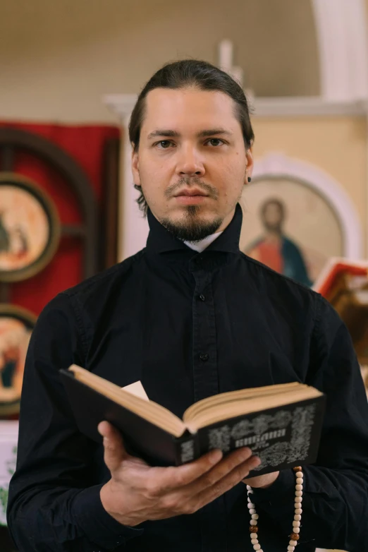 a priest holding the bible in a church