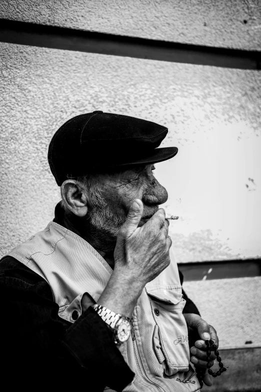 a man in a dress clothes smoking a cigarette