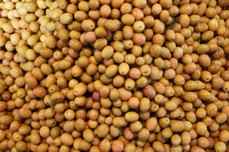 a pile of nuts that are for sale on the shelf