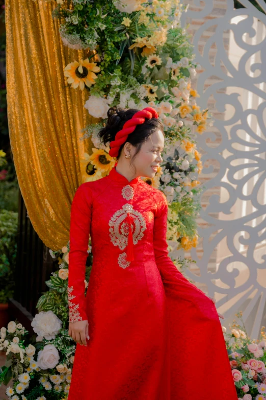 the woman is dressed in red near flowers