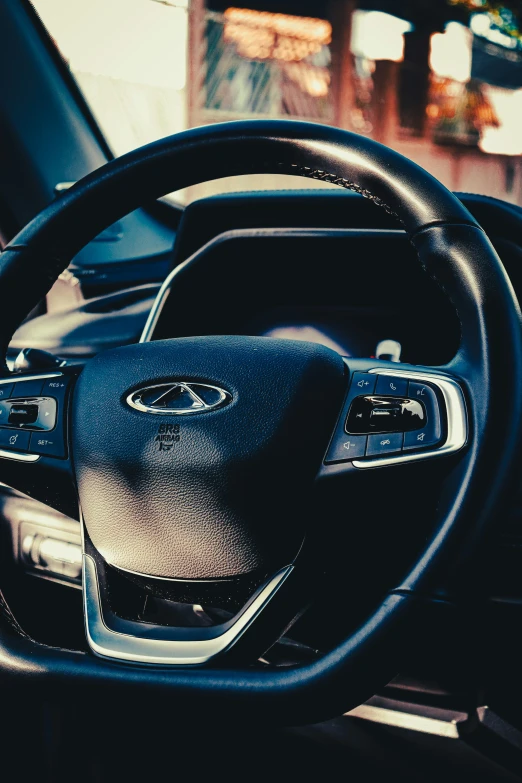 the steering wheel of a car in a city street