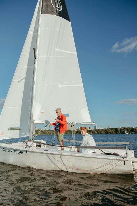 two men are sailing in the water together