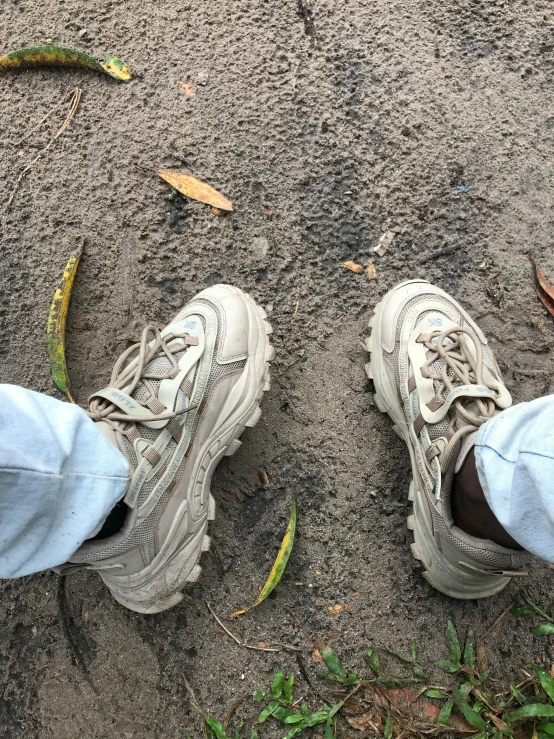 someone is standing in dirt with their shoes on