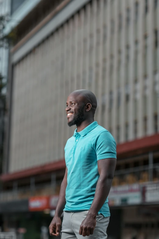 a man standing in front of some tall buildings