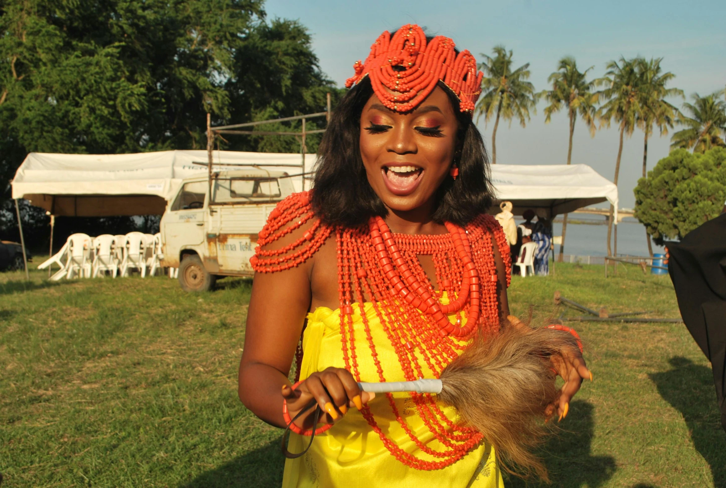 a girl is smiling and brushing her hair