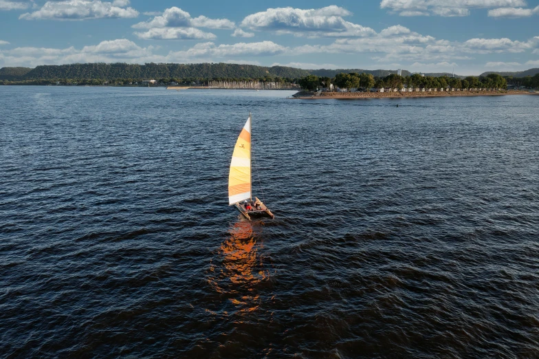 a wind surfer is floating down a river