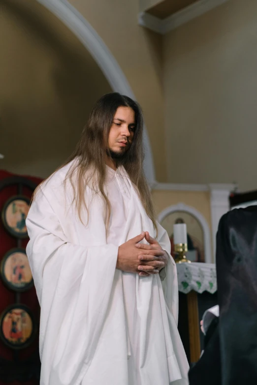 a religious man stands in his room and looks forward