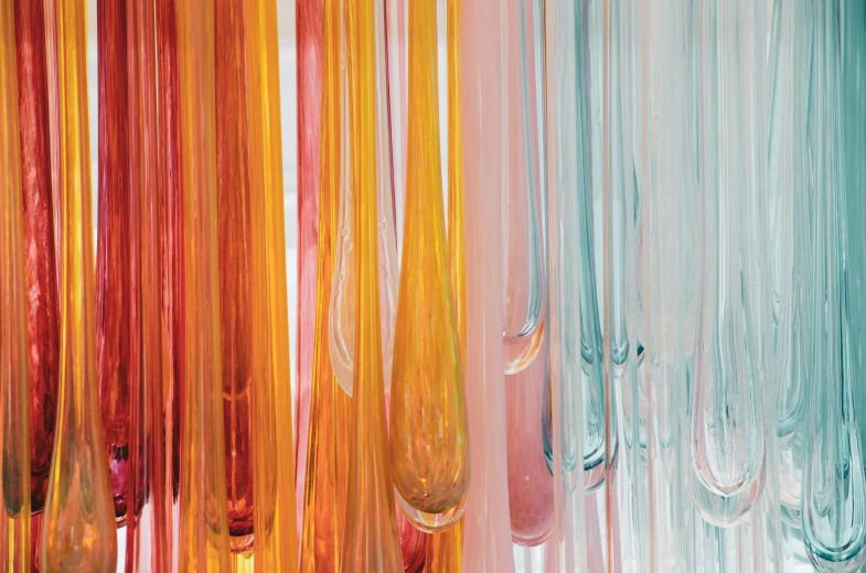 colorful objects hanging from the ceiling in front of each other