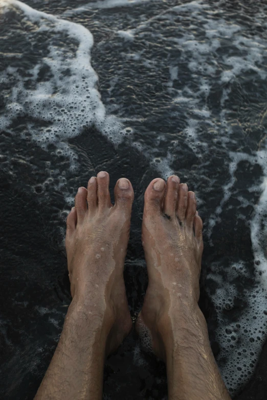 a person is standing at the edge of a wave