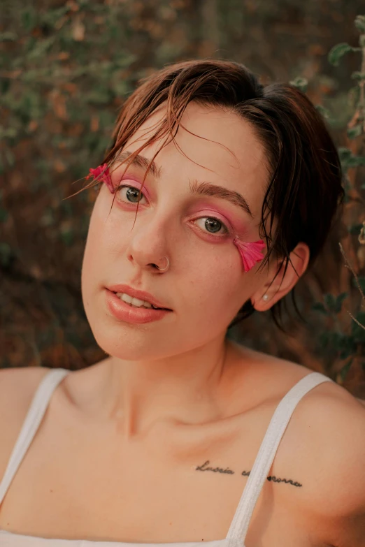 a close up of a person posing with makeup