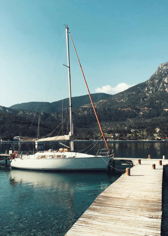 a boat is docked at the pier of a marina