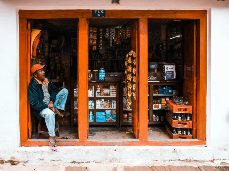 there is a man sitting in the window selling goods