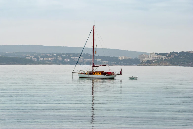 a sailboat sailing on a body of water