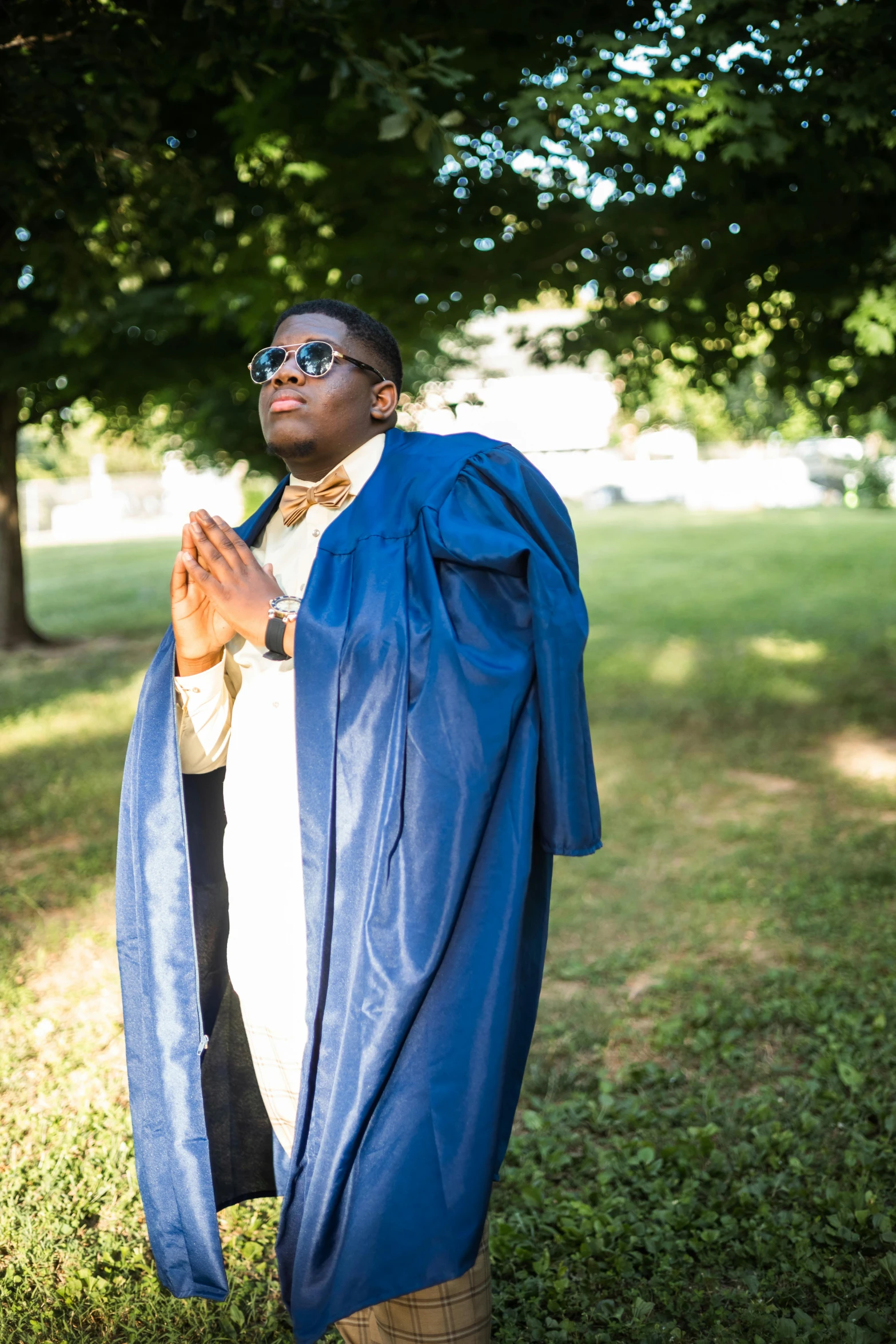 the man in glasses has a blue robe over his shoulders