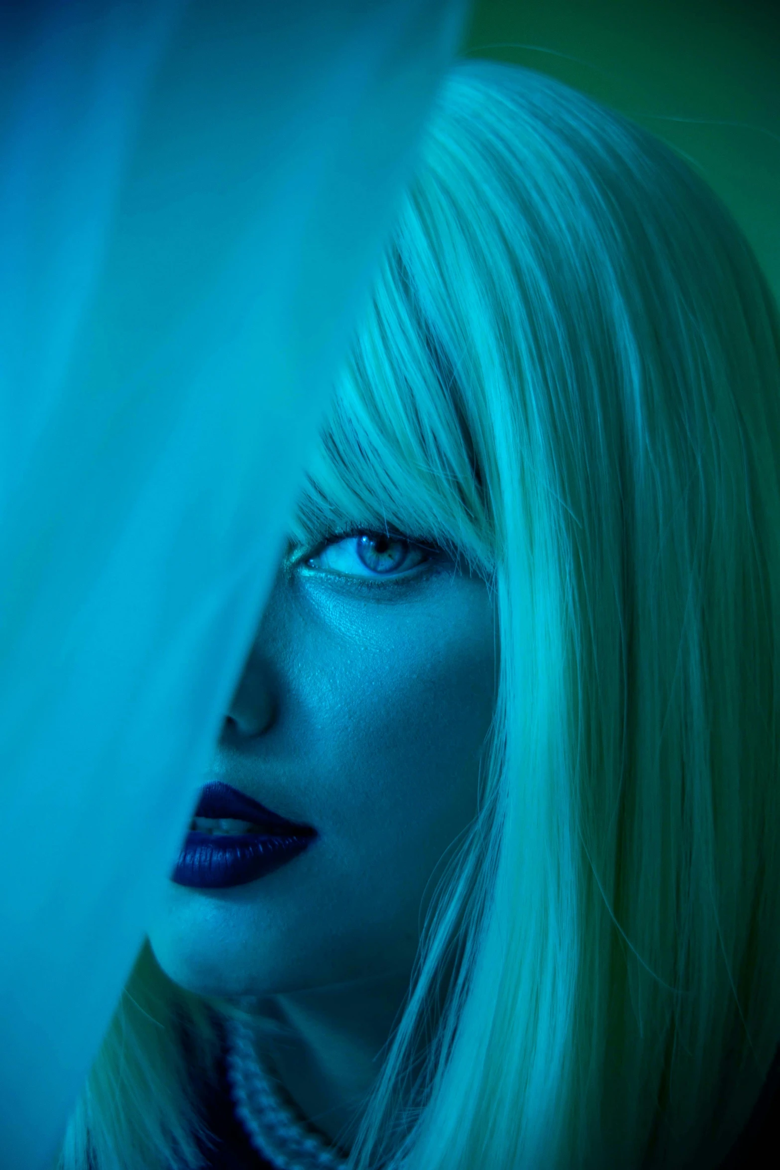 a girl with blond hair and blue makeup