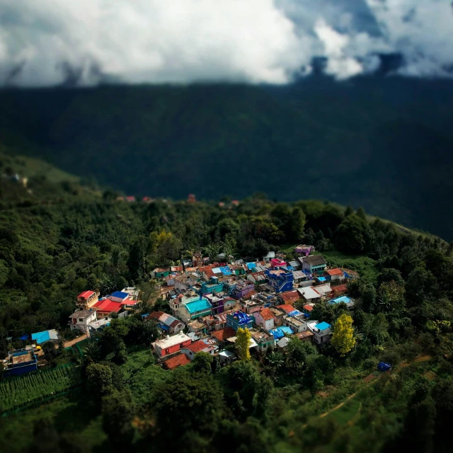 the bird eye view of a very colorful village on the side of a mountain