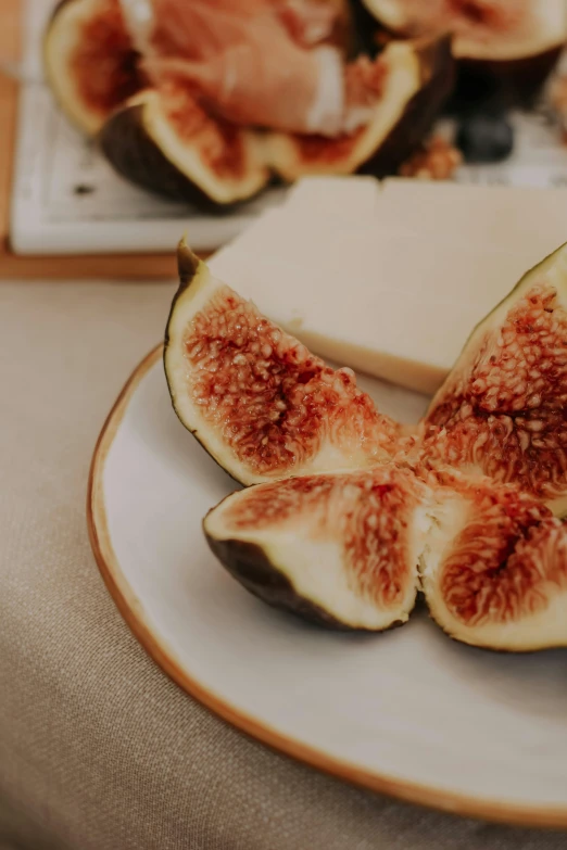 plate of figs and cheese on wooden table