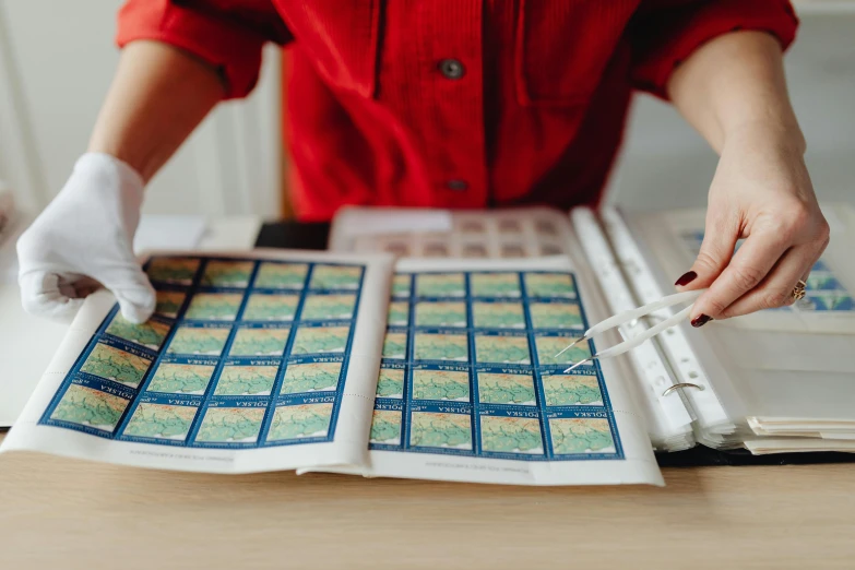 the woman is working on printing soing on a desk