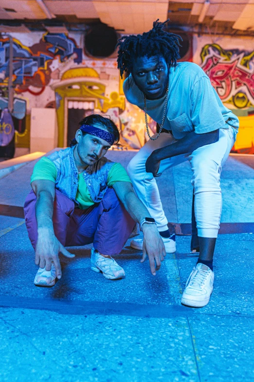 two men with skateboards are standing in front of a building