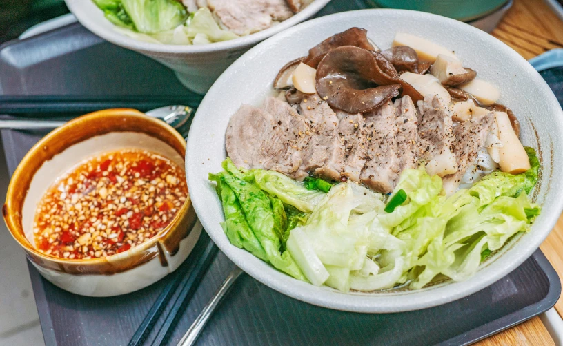 a bowl and bowl filled with meat and vegetables