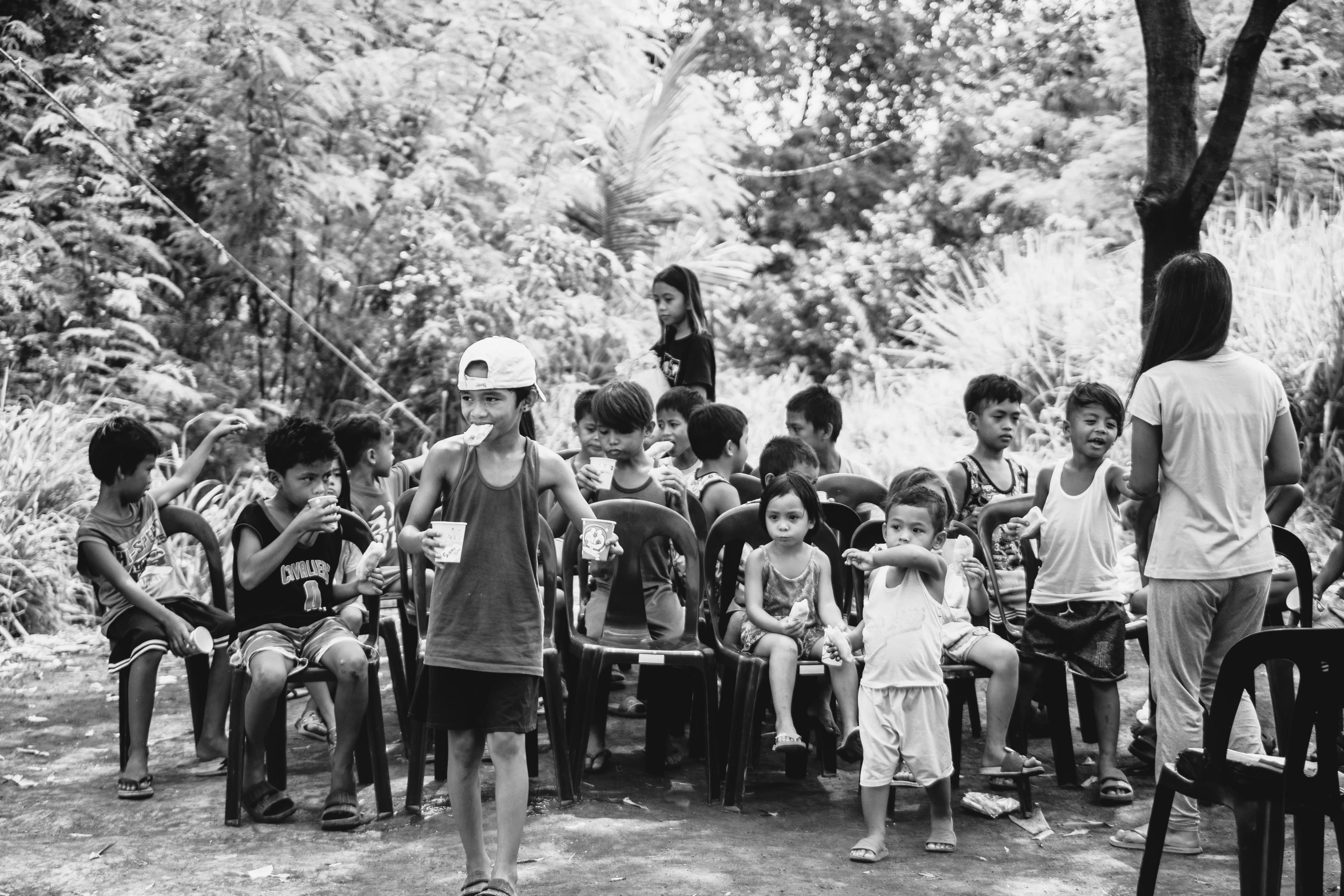 a group of s with adults standing in front of them