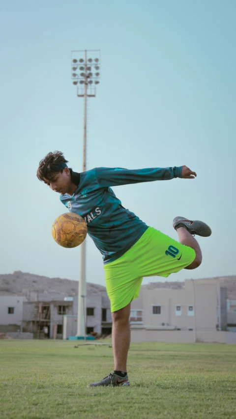 a man on a field holding a soccer ball