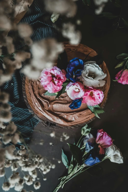 a basket with flowers on it sitting next to another basket