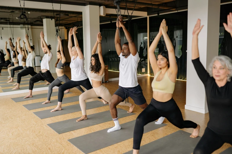 a group of women doing yoga in a gym