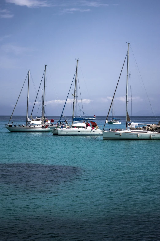 a number of boats in the water near one another