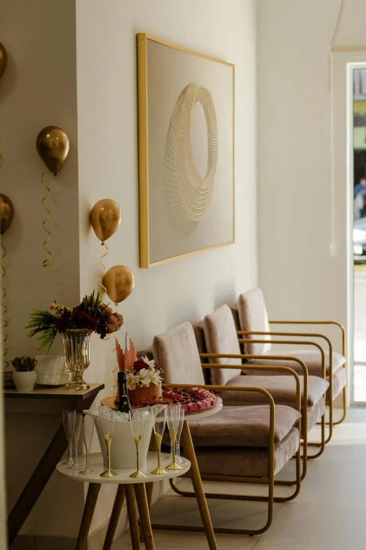 a living room has wine glasses and champagnes on the table