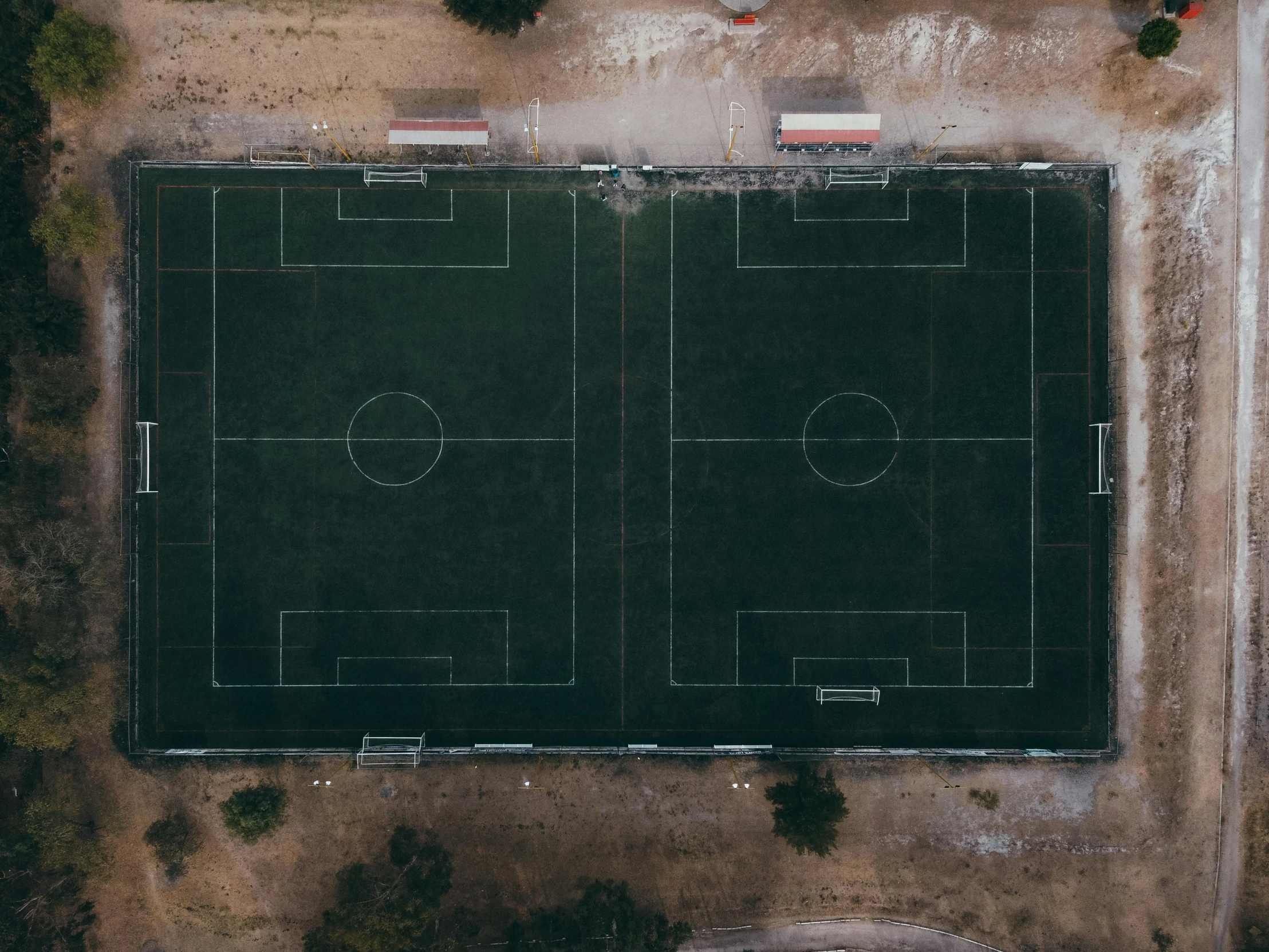 an aerial s of a football field surrounded by dirt