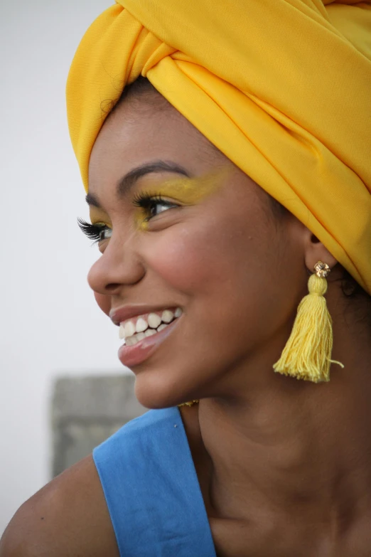 a woman is wearing bright yellow accessories to make her look like she is smiling
