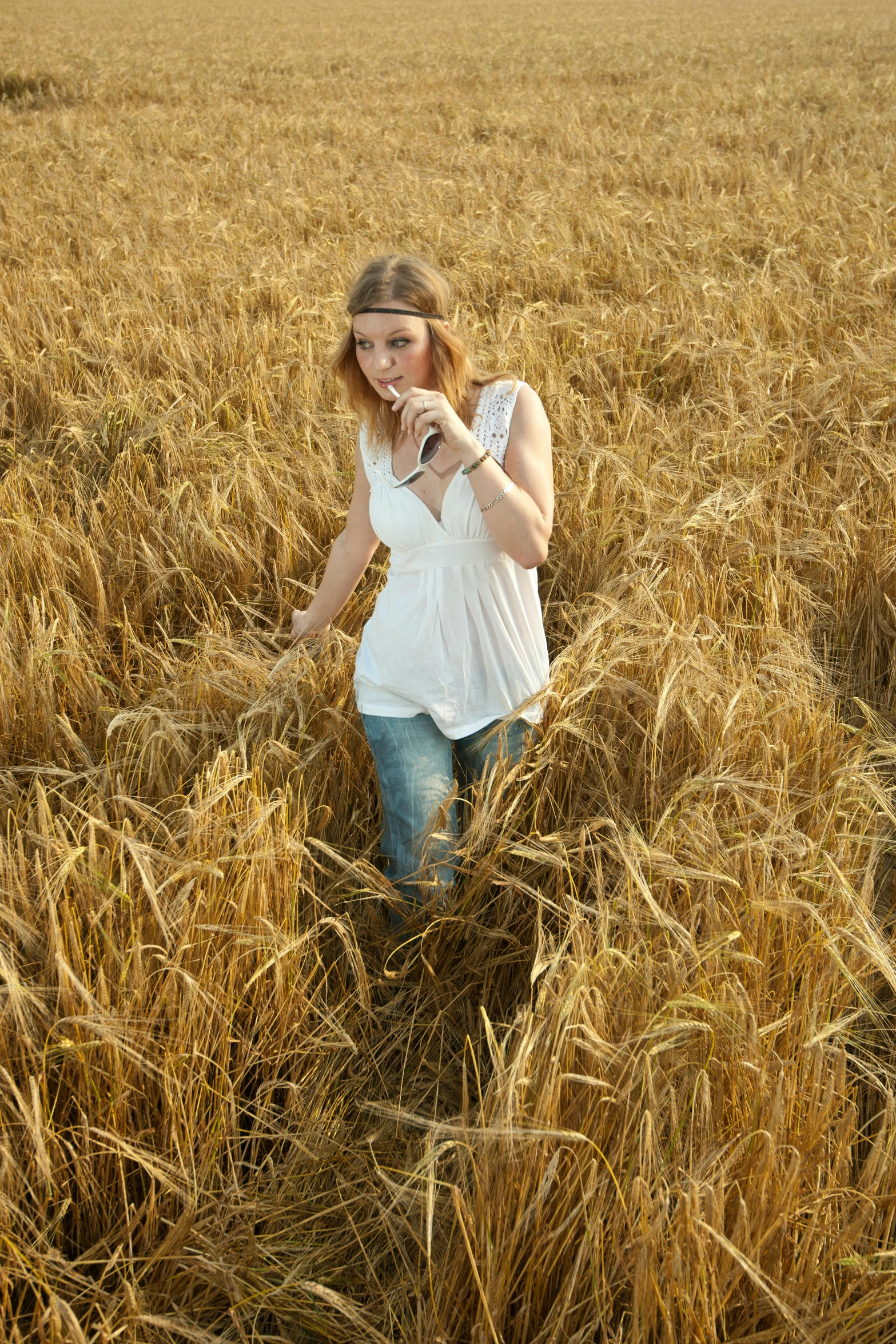 a woman standing in the middle of a field