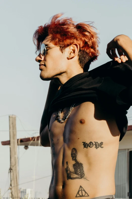 a shirtless male with red hair and a shaved back