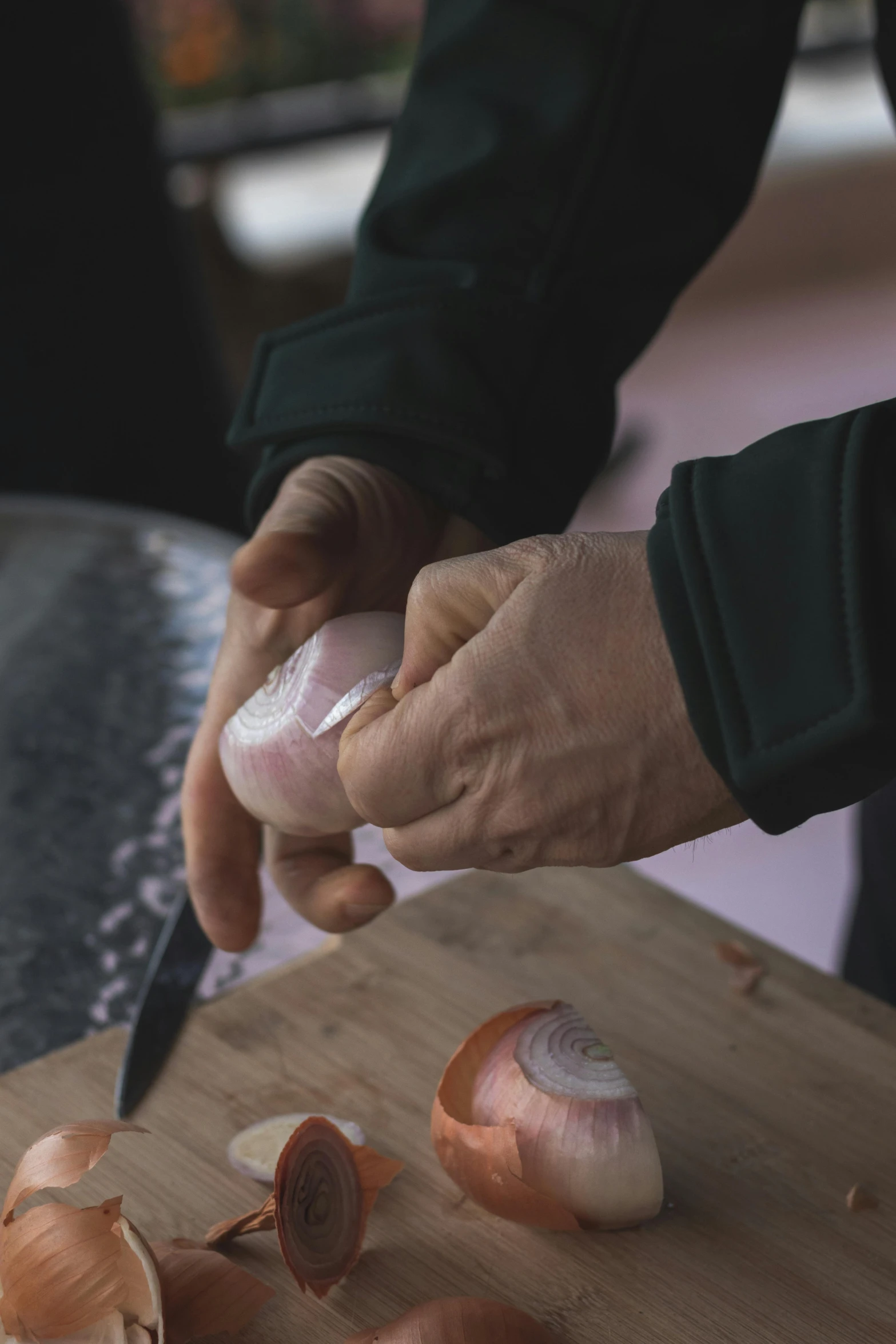 a person holding a knife chopping up onions