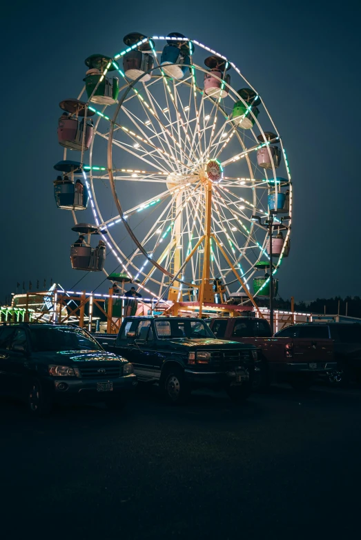 the big wheel is brightly lit up in a dark sky