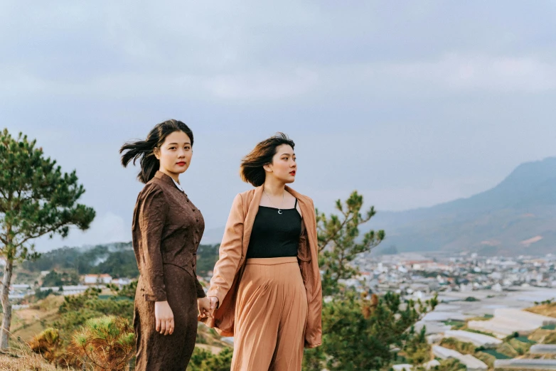 two people standing together near the city of medini