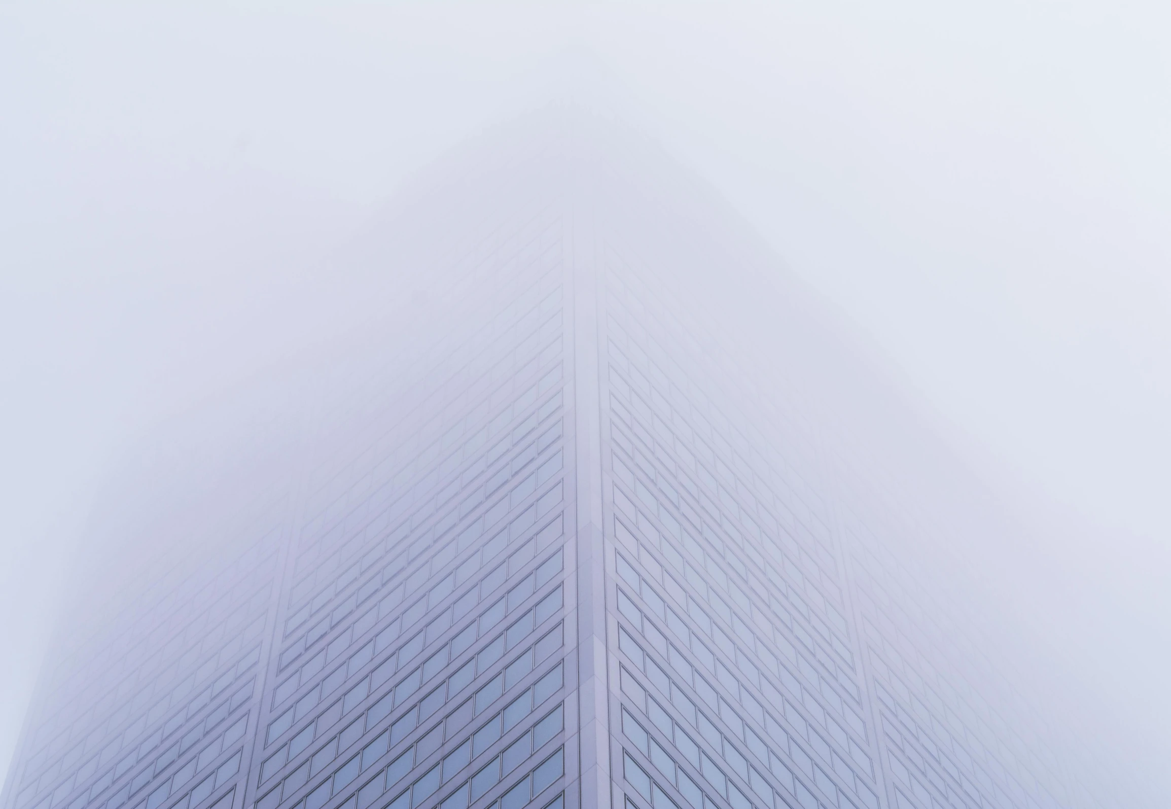 an office building is shown from the bottom in the fog