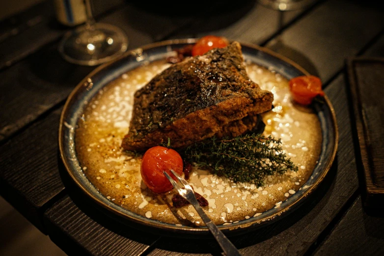 the food is served with red tomatoes and herbs