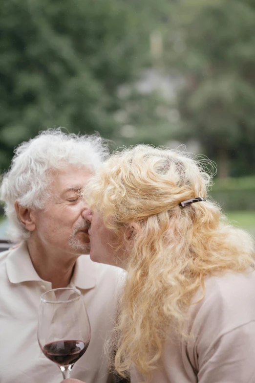 two old people who are kissing each other