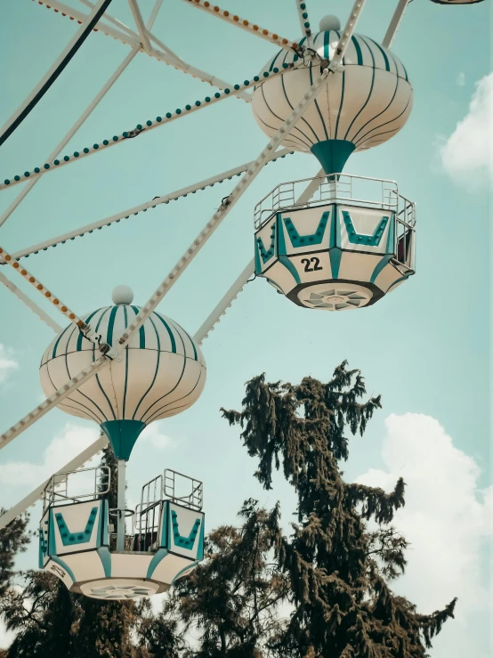 several lights are hanging above trees and a sky background