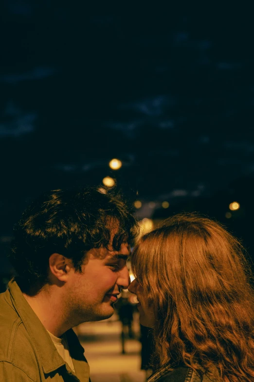 two people standing side by side and one person has his chin on the other