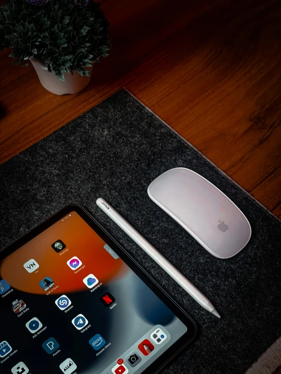 an iphone sitting on a desk next to a mouse pad and a mousepad