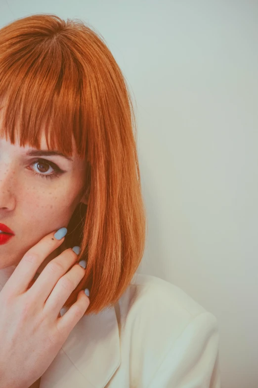 a girl with bright red hair posing for the camera