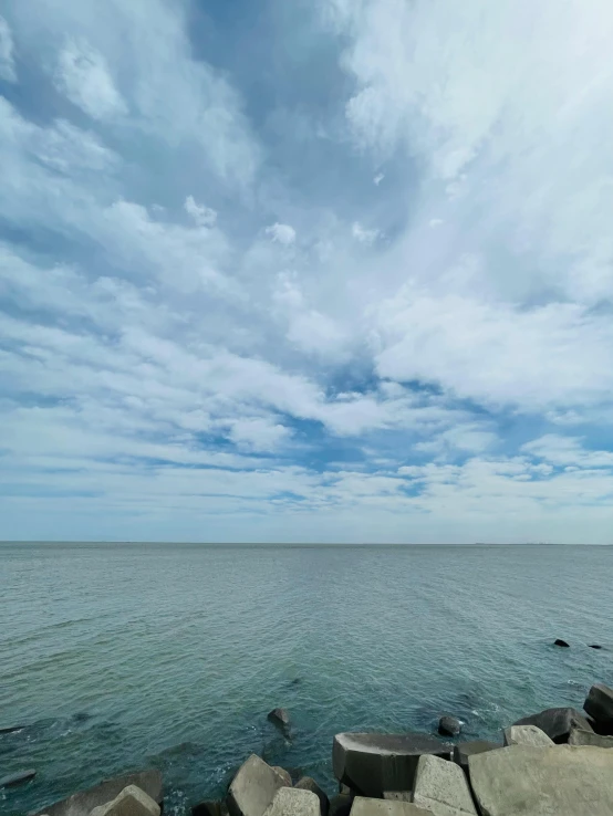 some rocks and water under a blue sky