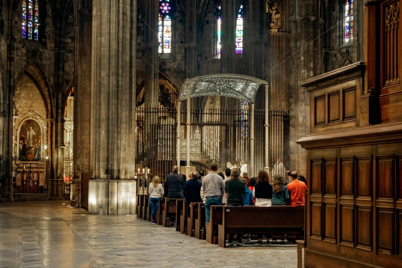 a group of people stand in the center of a church