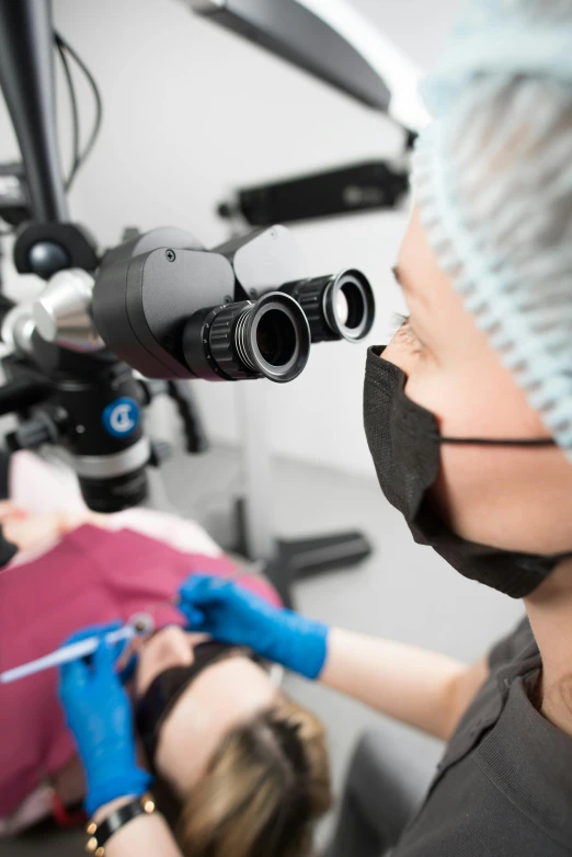 a woman who is getting eyeglasses fixed to a man